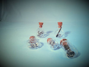 Small cork bottles with emergency spoons, random