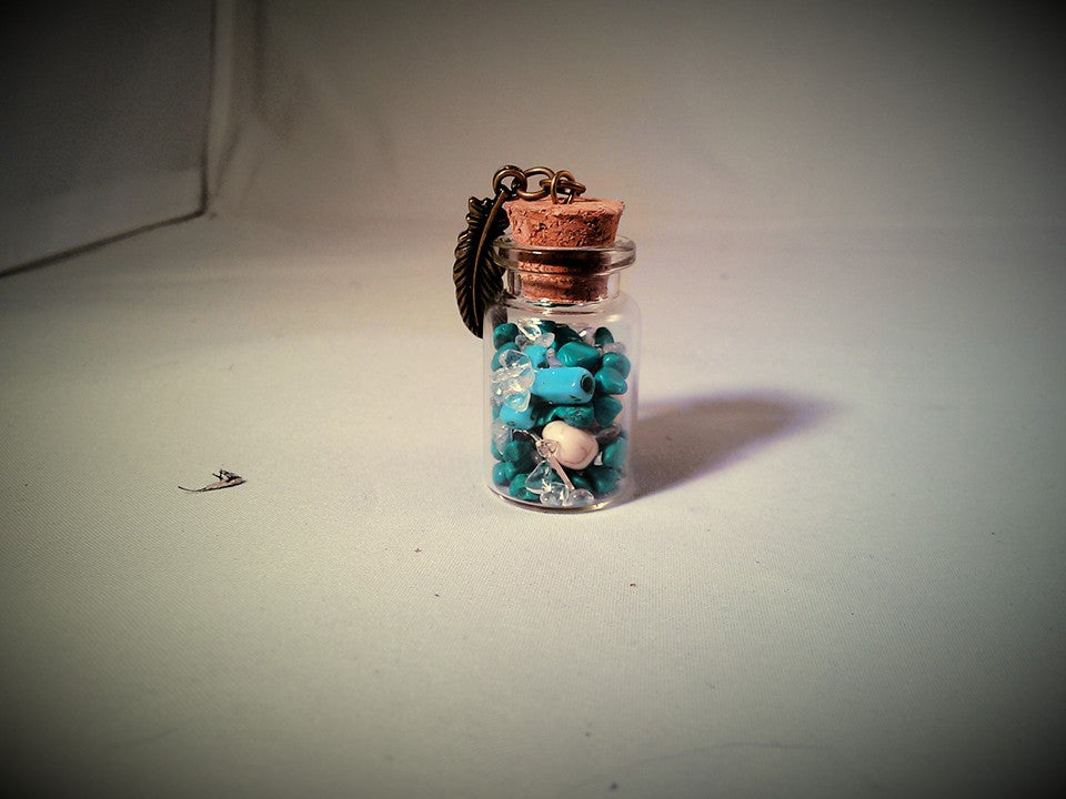 Turquoise skull gram of silver